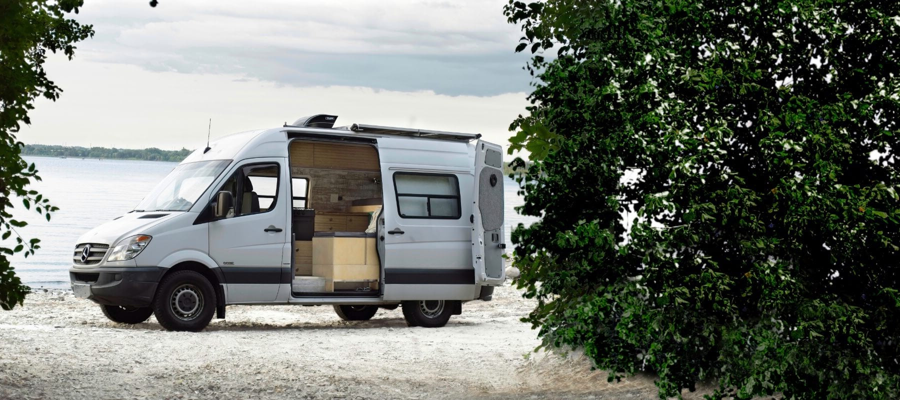Lonavity van parked by the Gatineau River, custom van conversion and rental