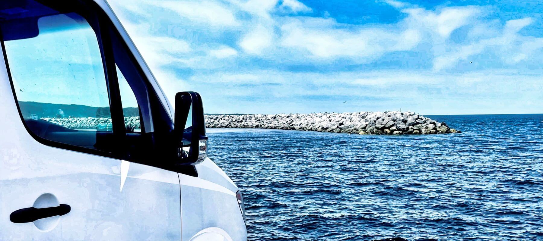 Lonavity van travelling in Quebec, parked by the Marina, beautiful view of the blue water in Rimouski