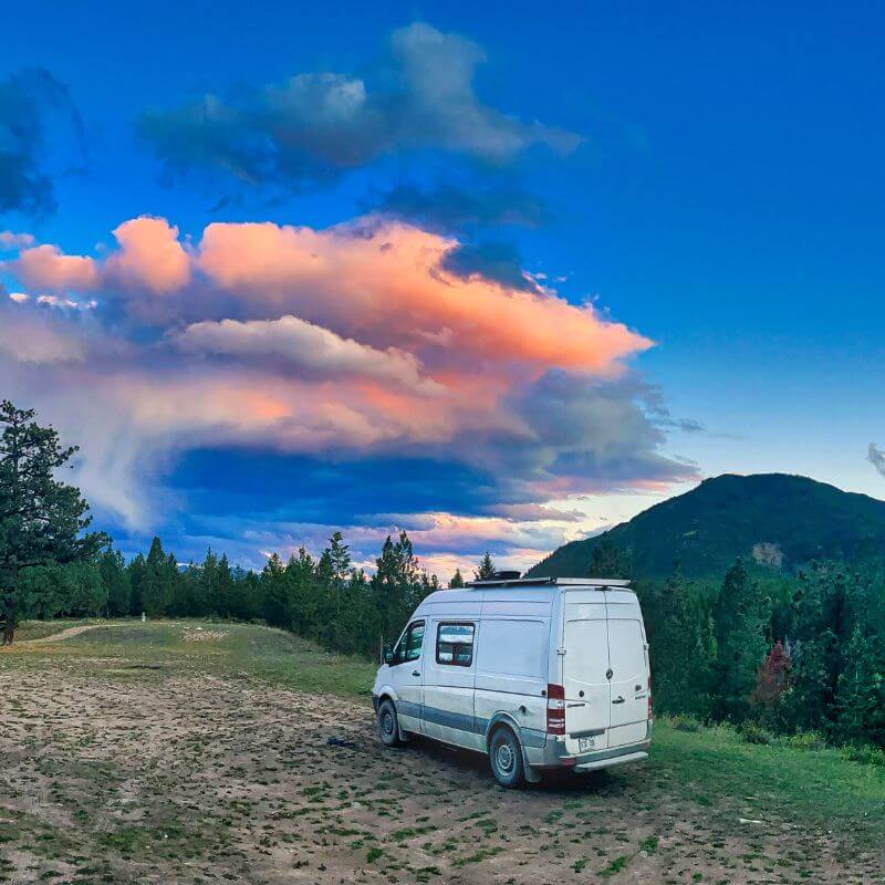Vanlife Beautiful view of the BC Mountains Blue Sky and Pink Clouds Boondocking, custom van conversion made by Lonavity