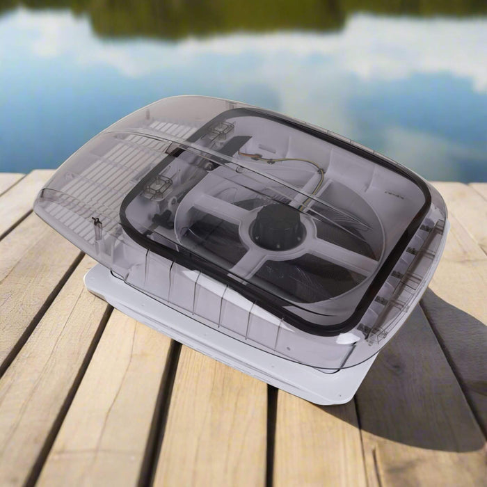 Open roof fan installed in a camper van with reversible airflow and integrated LED lights / Ventilateur de toit ouvert installé dans un van aménagé avec flux d’air réversible et LED intégrées.