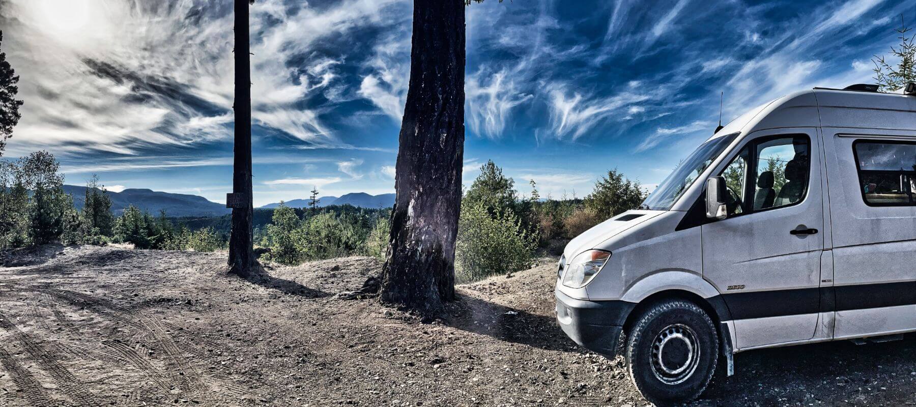 Environmental Commitment, Lonavity Van parked at Whisky Creek in BC by a mountain, a beautiful sun. Lonavity is eco-responsible donates to reduce the carbon footprint.