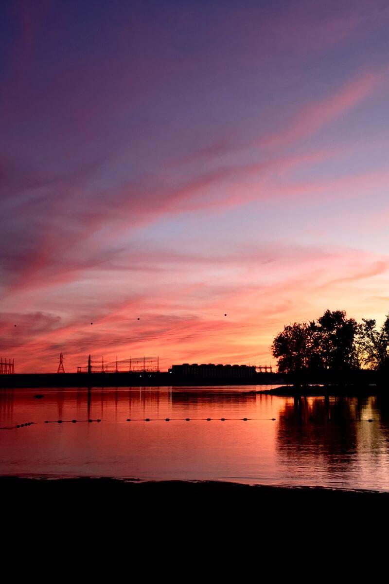 Lonavity blogs, camping in Ontario with the converted van, beautiful red sky by the water, rent the van to explore Canada