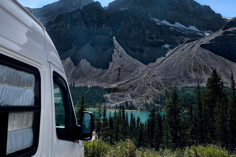 Lonavity traveling canada in their converted van,  beautiful view of the mountains in BC and blue water.