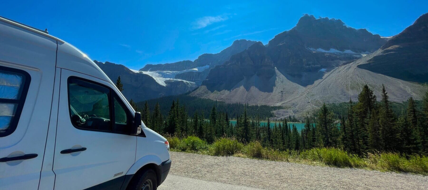 Lonavity van conversion, rental and products, travelling in Jasper, parked by the blue river and big mountains, Vanlife Canada explores the roads