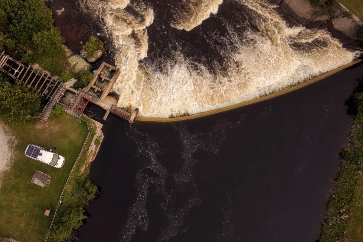 Vanlife Picture from high in the sky seing a van conversion made by Lonavity. View of a beautiful waterfall in Sainte-Jeanne-d'Arc, Québec