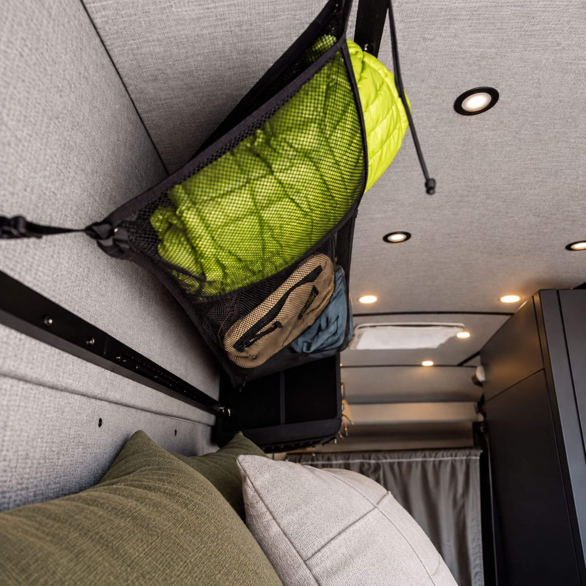 Large 45 x 17 inch cargo net with mesh and fabric pockets for maximizing campervan and RV storage.
