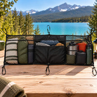 Large cargo net organizer with adjustable mounting straps, mesh pockets and fabric compartments for vanlife storage.