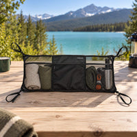 Compact cargo net organizer with adjustable mounting straps and mesh pockets for vanlife gear storage.