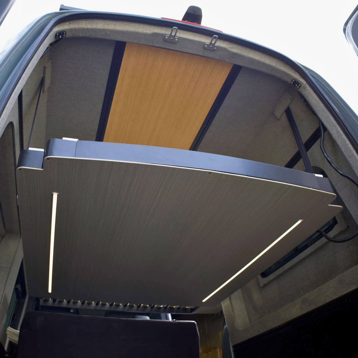 Expandable sliding bed that widens the sleeping area in a campervan conversion