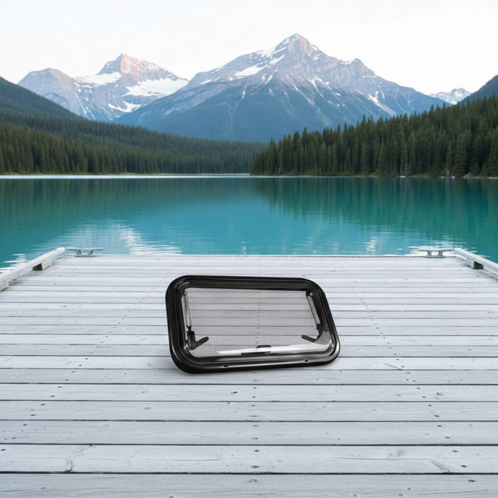 Modern van conversion window with awning-style opening, adjustable airflow, integrated blackout blind, and fine mesh insect screen for comfort and privacy.