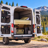 Ford Transit rear door storage panels with multiple black fabric pockets for organized campervan gear and travel essentials.
