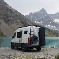 Sprinter van equipped with aluminum running boards in an open outdoor landscape