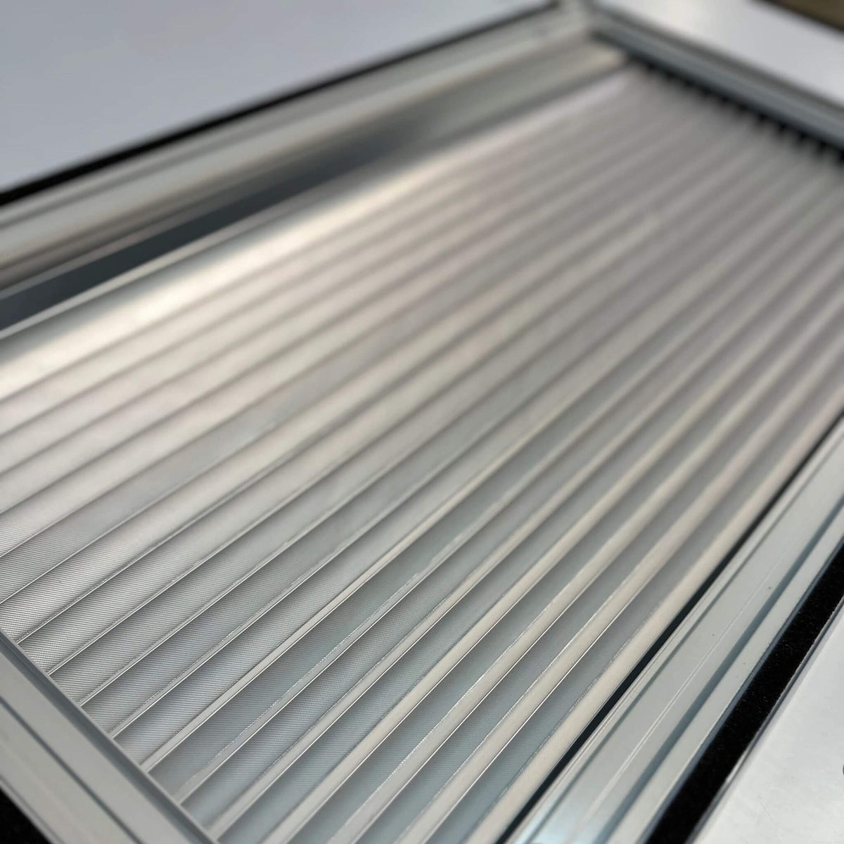 Curved awning window with integrated blackout blind and insect screen