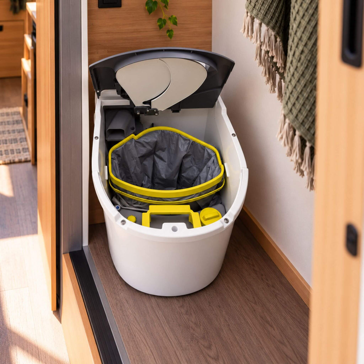 Separett Tiny composting toilet with open lid showing the urine-diverting system inside a campervan.