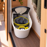 Separett Tiny composting toilet with open lid showing the urine-diverting system inside a campervan.