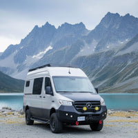 Aluminum running boards with drop-down step on a Sprinter ready for the road