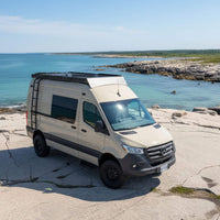 Sprinter carbon fiber rooftop tent system with integrated roof rack set up for long summer road trips