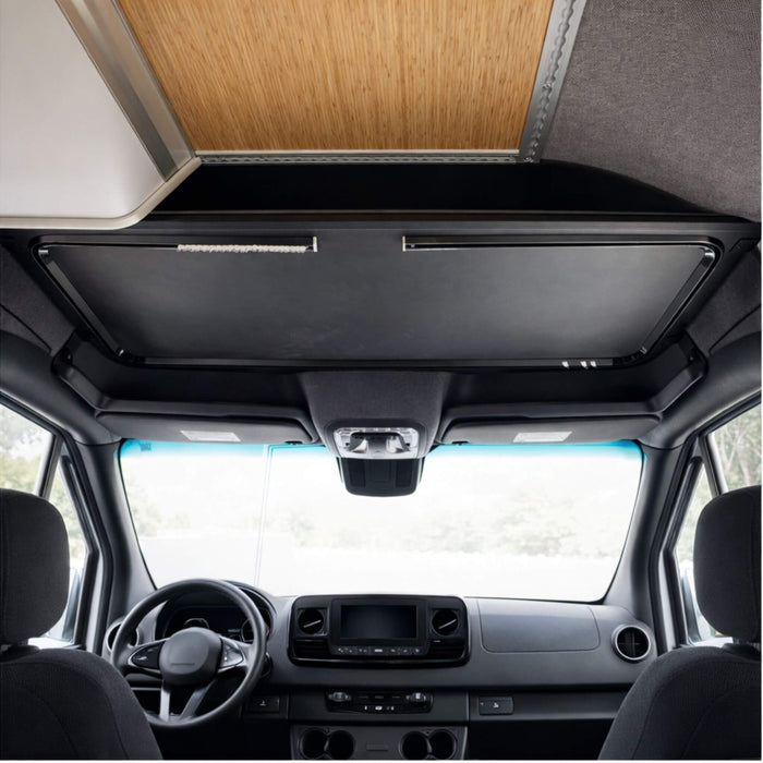 Aluminum headliner shelf installed above the cockpit in a Sprinter, providing clean overhead storage without reducing headroom.