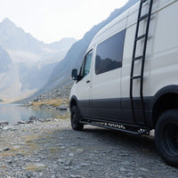 Sprinter aluminum running boards with drop-down step parked in a quiet natural setting
