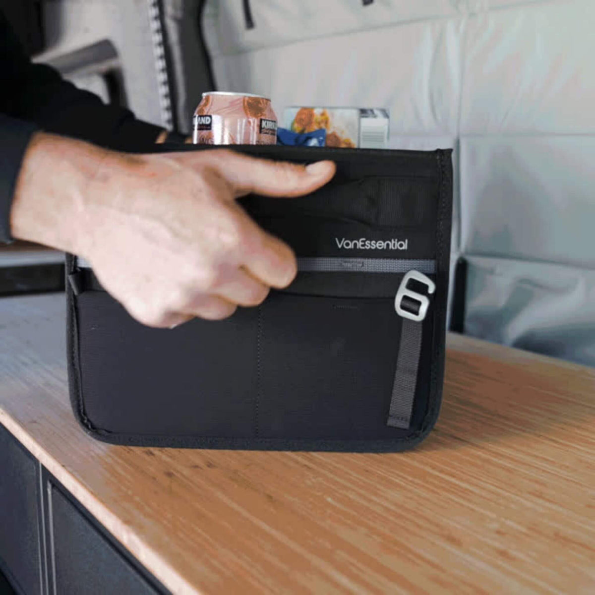 Carrying the VanEssential 18 L collapsible storage box by its handles.