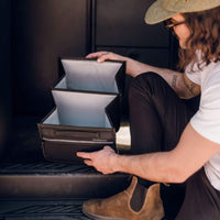 Unfolding the VanEssential 18 L collapsible storage box on a van floor.