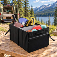 Boîte de rangement pliable VanEssential 44 L remplie d'équipement de camping et de sport près d'un lac.