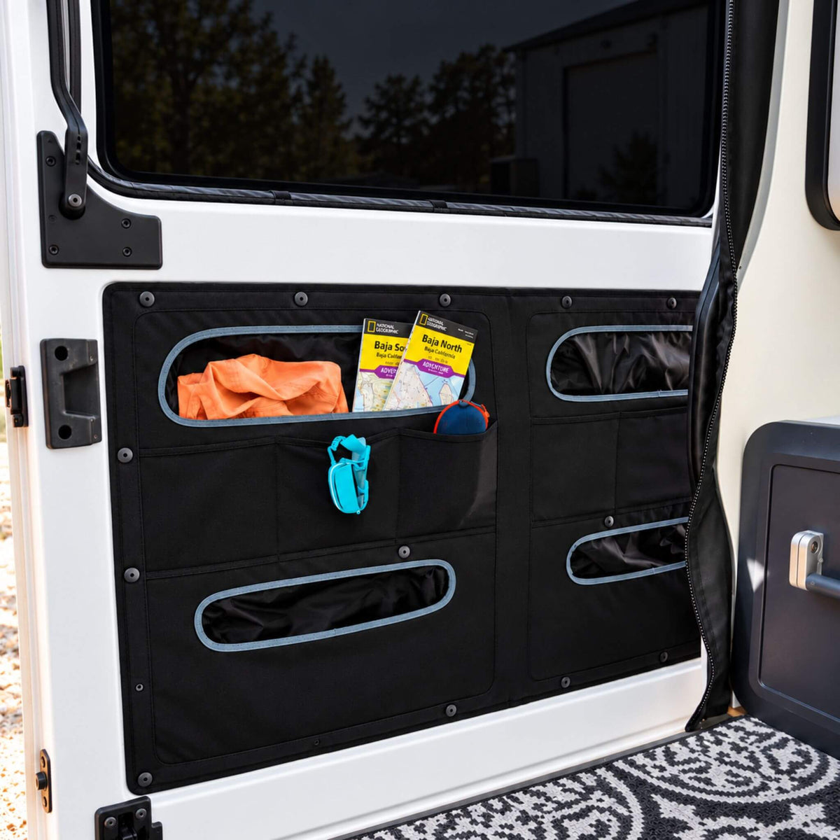 VanEssential Ram ProMaster sliding door storage panel, a campervan organizer with mesh pockets.
