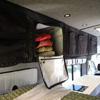VanEssential upper storage cabinet with mesh pockets and daisy chain for quick-access gear in an RV.